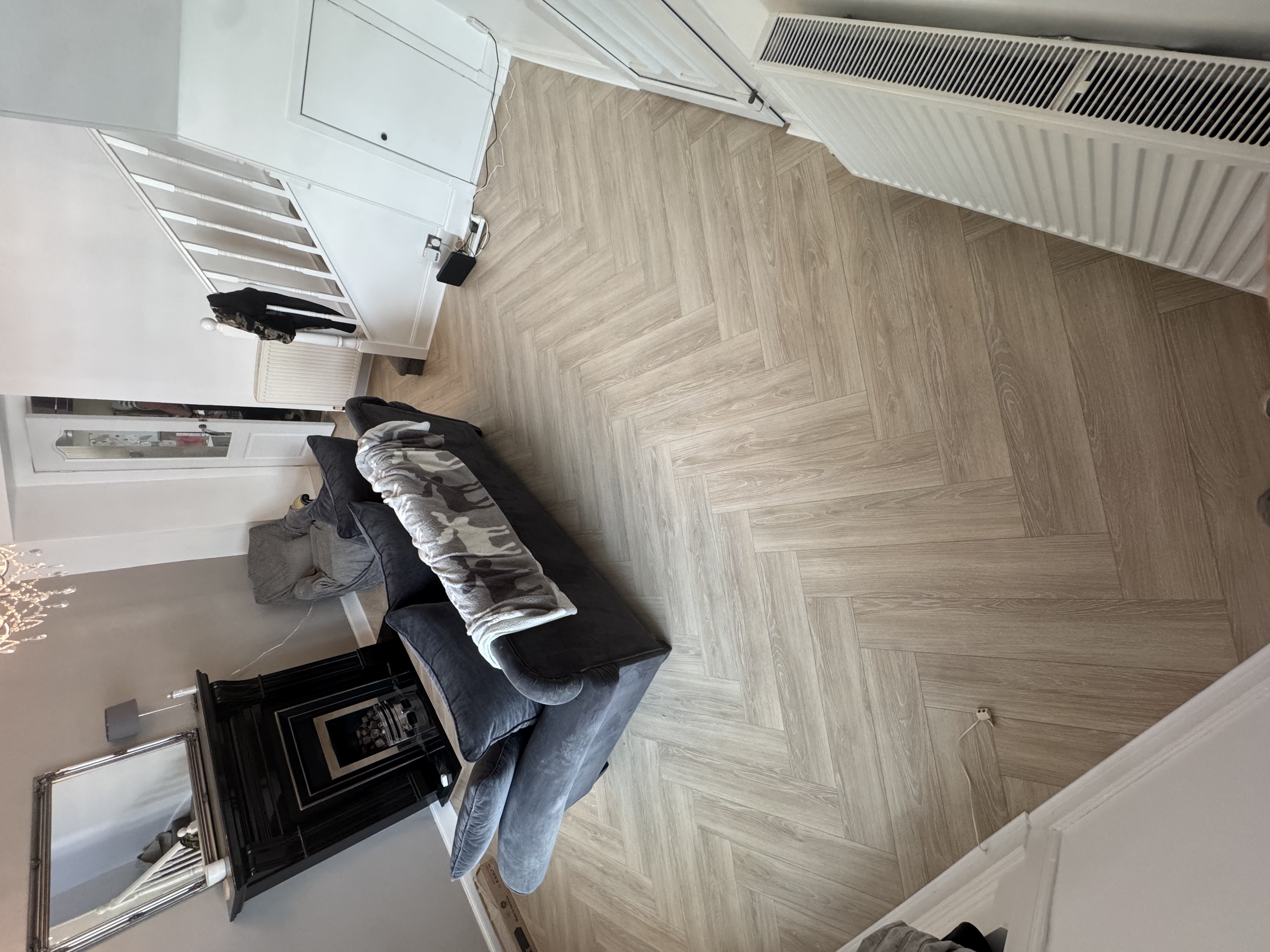 Grey herringbone flooring in a living room