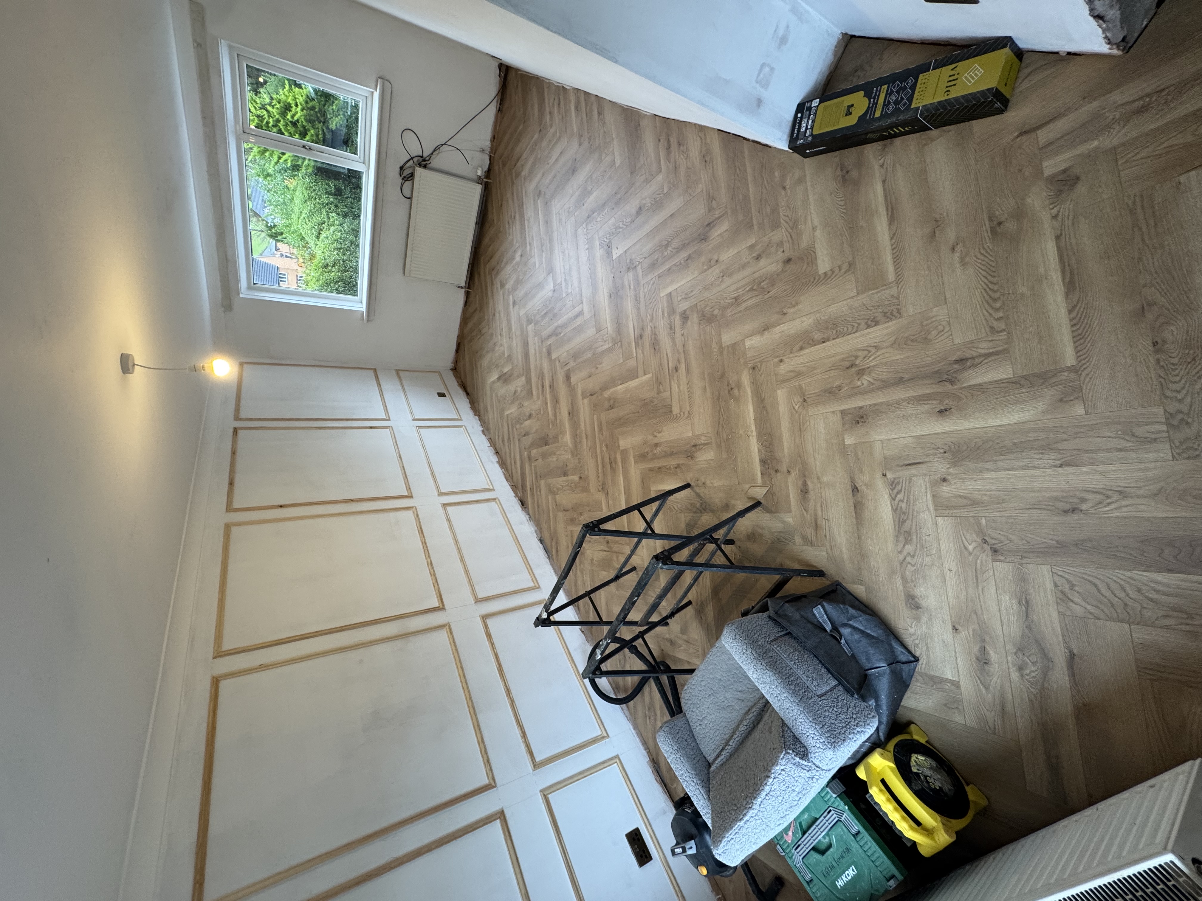Herringbone flooring installation in progress