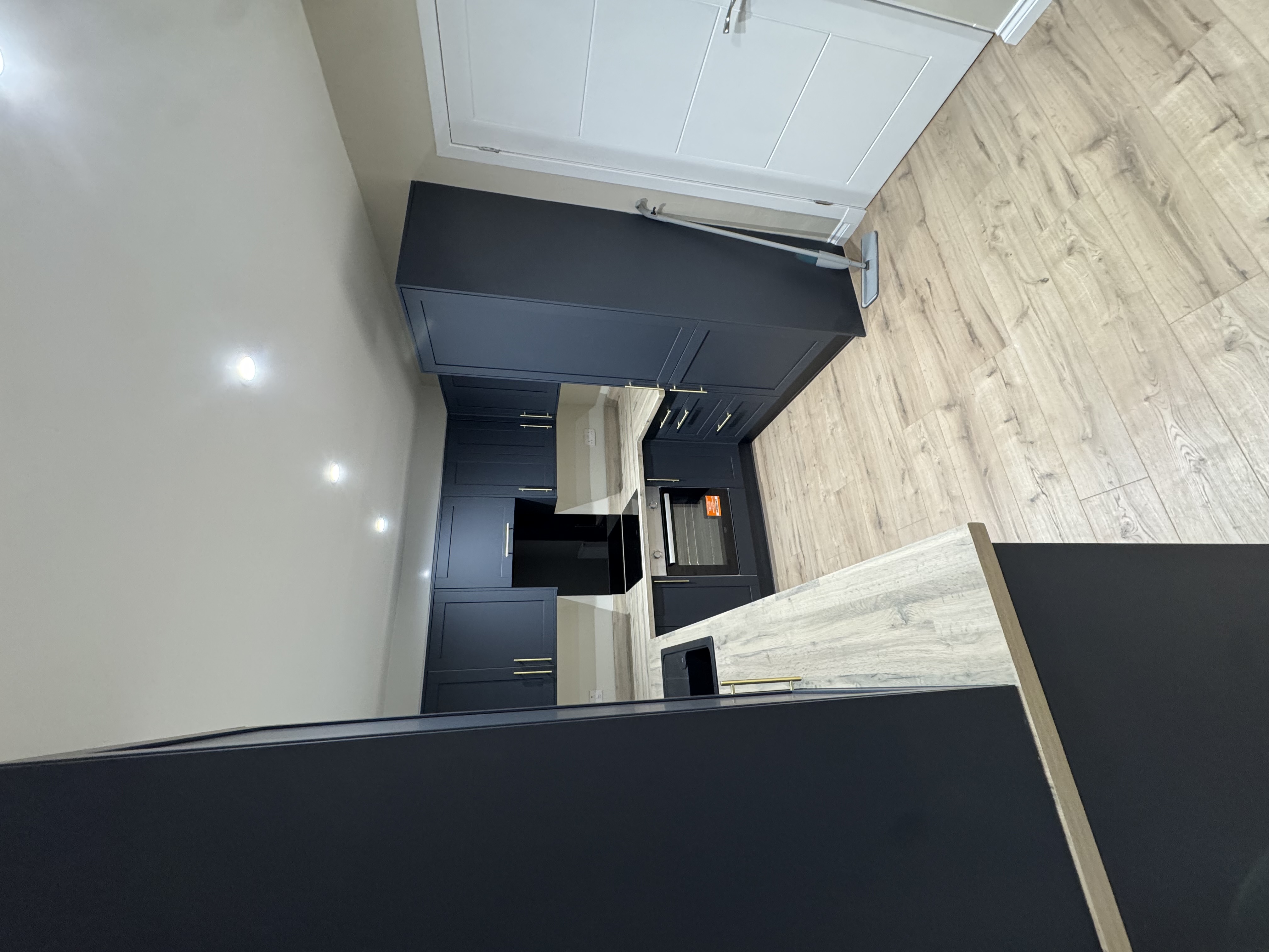 Navy kitchen with integrated oven