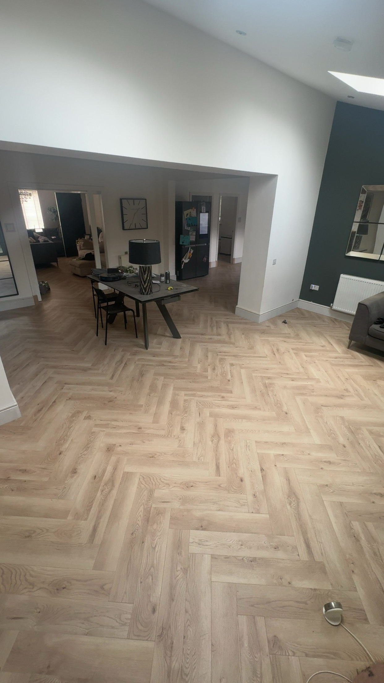 Herringbone flooring in open-plan living and dining space