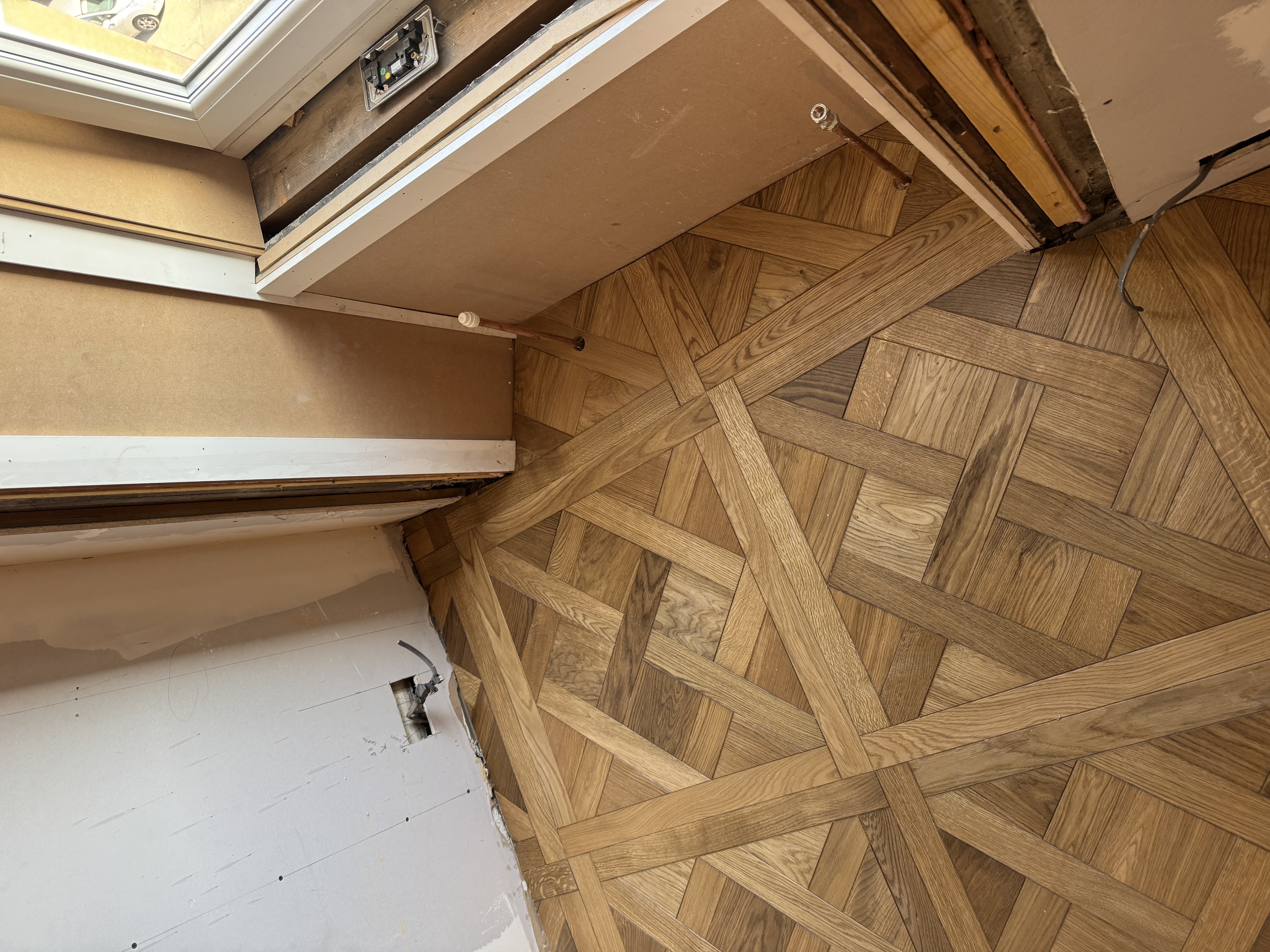 Parquet basket-weave flooring installation under a skylight