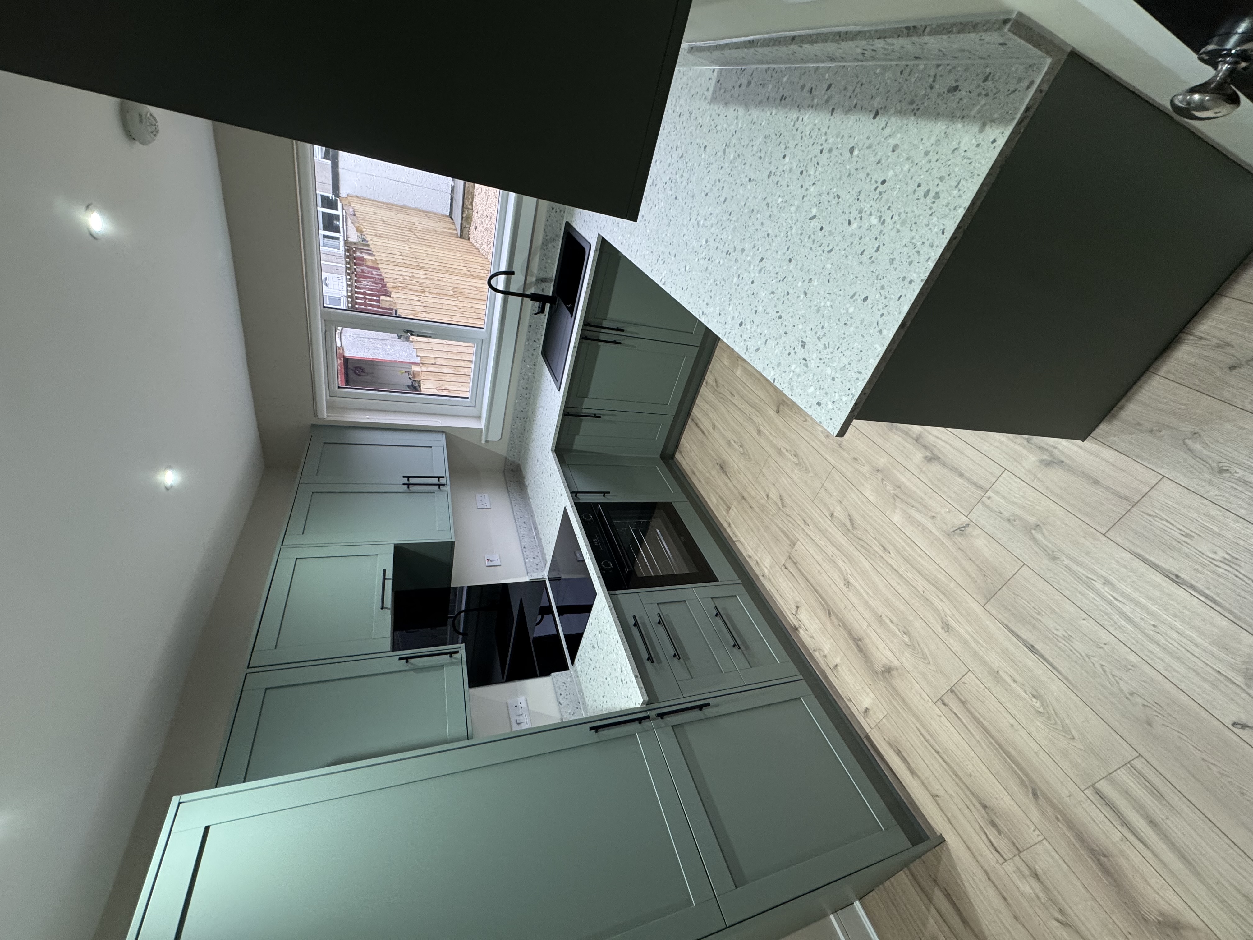 Sage green shaker kitchen installation